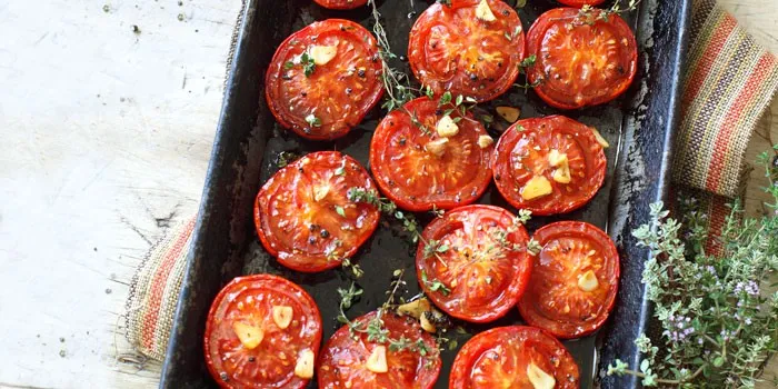 Tomatoes with garlic and herbs on tray